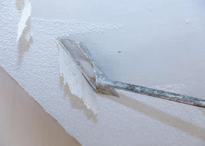 applying drywall mud to ceiling