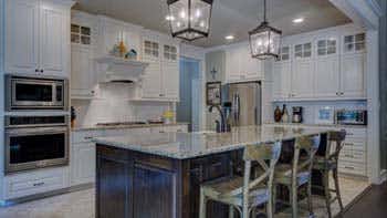 refinished white kitchen cabinets in Victoria home by Envision Painting